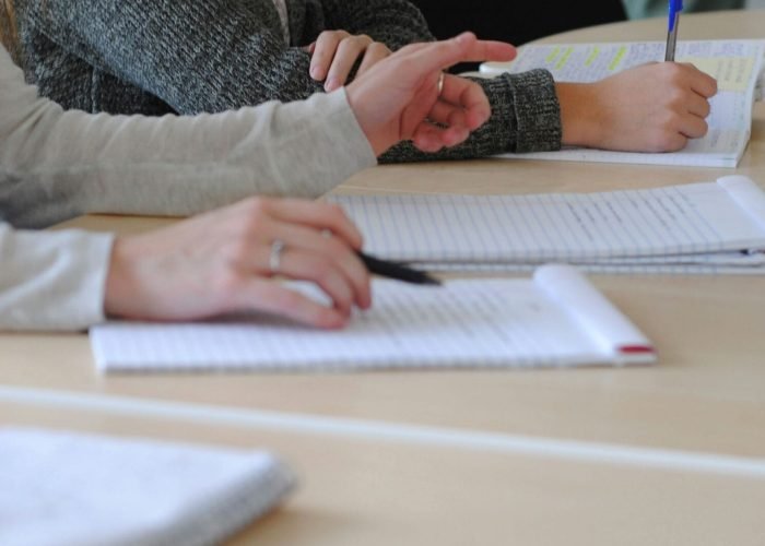 a woman writing on a piece of paper